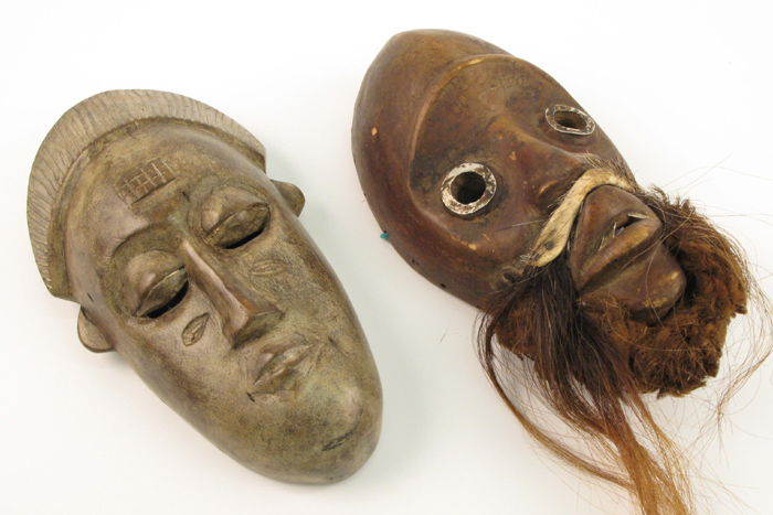 Appraisal: TWO AFRICAN IVORY COAST CARVED WOODEN MASKS the first of