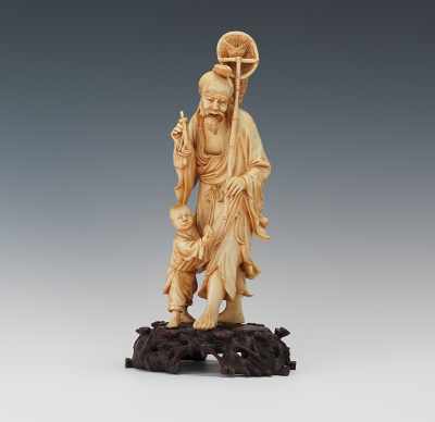 Appraisal: Carved Ivory Fisherman with Child Nicely detailed carved ivory fisherman