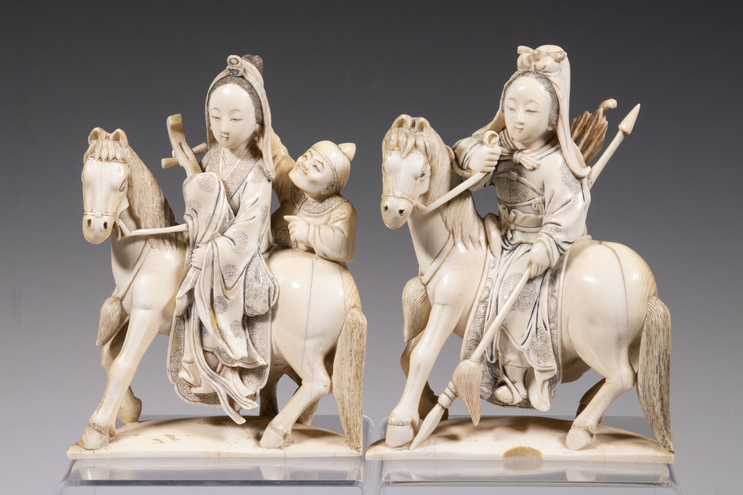 Appraisal: CHINESE QING CARVED IVORY PAIR OF WOMEN ON HORSES Late