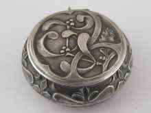 Appraisal: A French silver powder compact with raised decoration depicting mistletoe