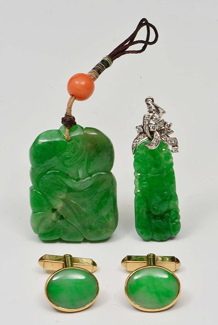 Appraisal: TWO GREEN CARVED JADE PENDANTS and a pair of jade