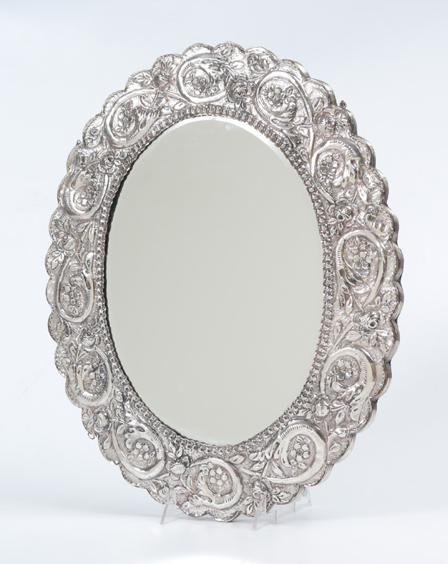 Appraisal: EMBOSSED SILVER WALL MIRROR Embossed frame with floral and foliate