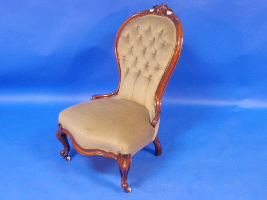 Appraisal: A Victorian walnut button upholstered spoon back chair with carved