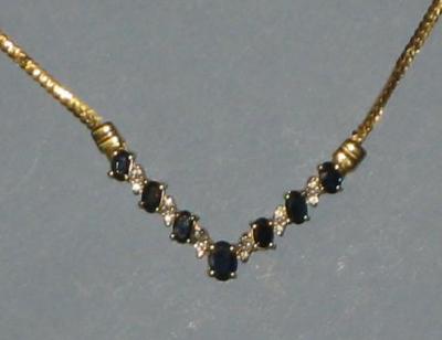 Appraisal: A SAPPHIRE AND DIAMOND SET NECKLET the V shaped panels