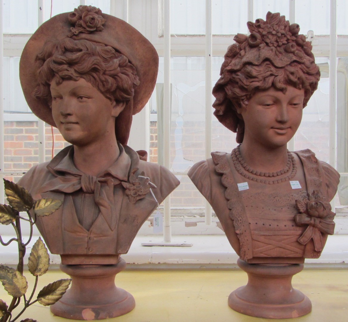 Appraisal: A pair of French terracotta busts of a youth and