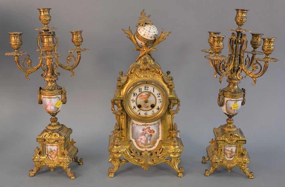 Appraisal: French gilt and enameled mantle clock with two matching candelabra