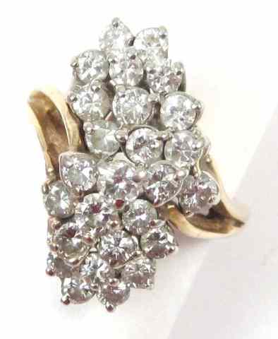 Appraisal: DIAMOND AND FOURTEEN KARAT GOLD RING The yellow gold cluster