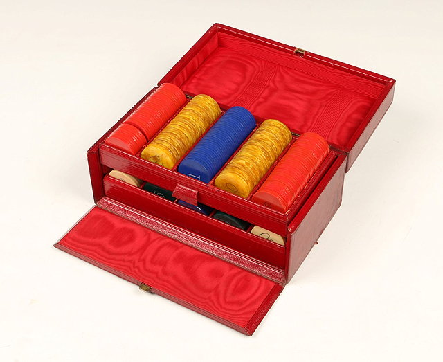 Appraisal: A SET OF GAMING COUNTERS in a red leather box