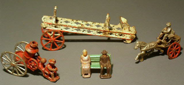 Appraisal: Group of cast iron toy pieces- fire pumper ladder wagon