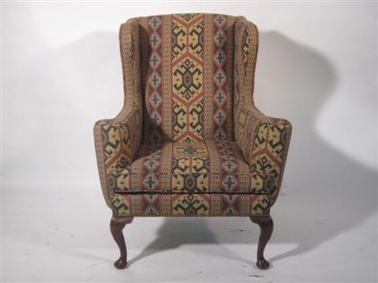 Appraisal: George III style mahogany wingback armchairThe upholstered back and enclosed