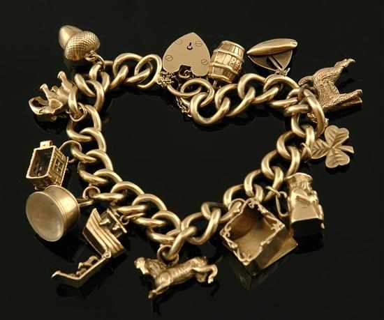 Appraisal: A gold charm bracelet The curblink chain set with twelve