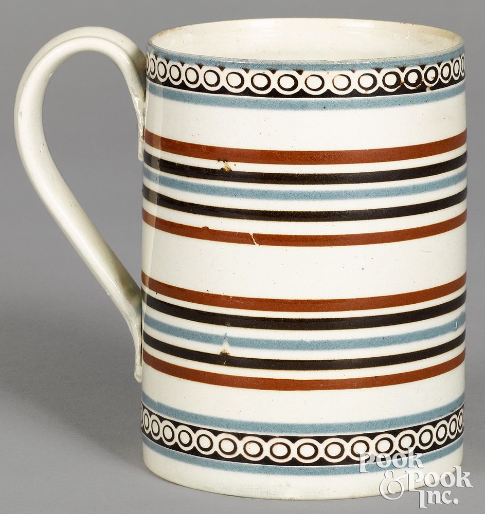 Appraisal: Mocha mug with blue and brown stripes Mocha mug with