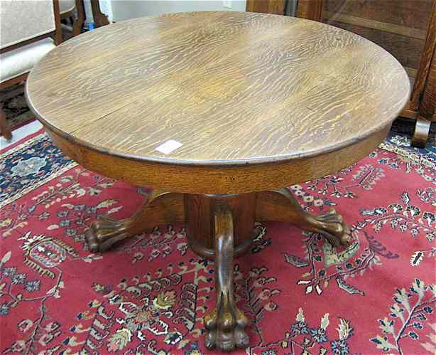 Appraisal: AN OAK PEDESTAL DINING TABLE WITH THREE LEAVES American c