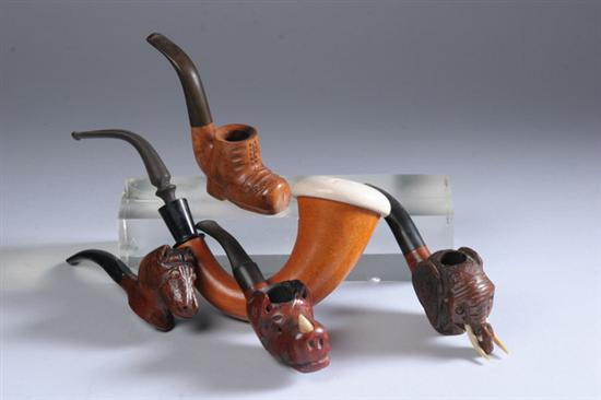 Appraisal: FOUR CARVED WOOD PIPES Including a shoe horse with glass