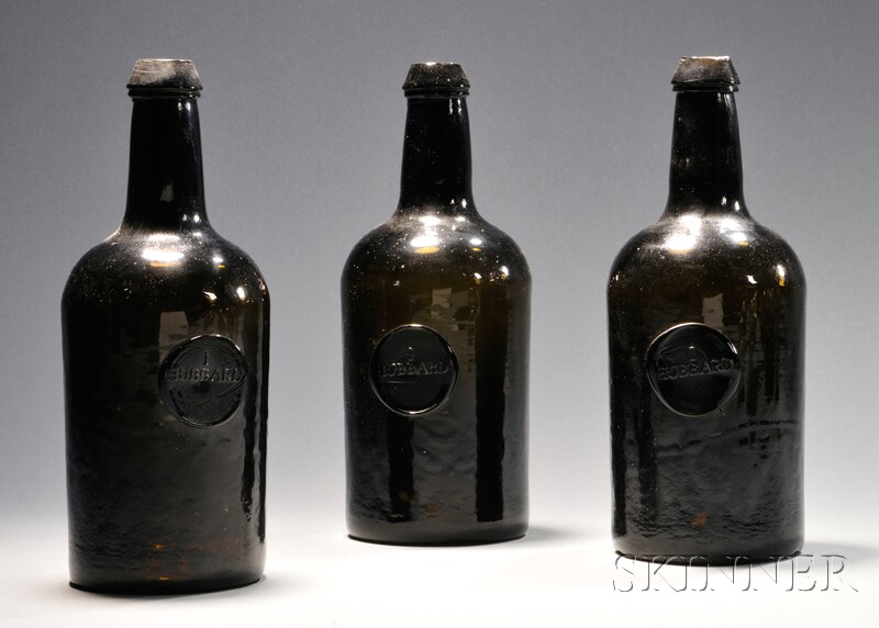 Appraisal: Three Olive-amber Wine Spirit Bottles with Seals probably New England