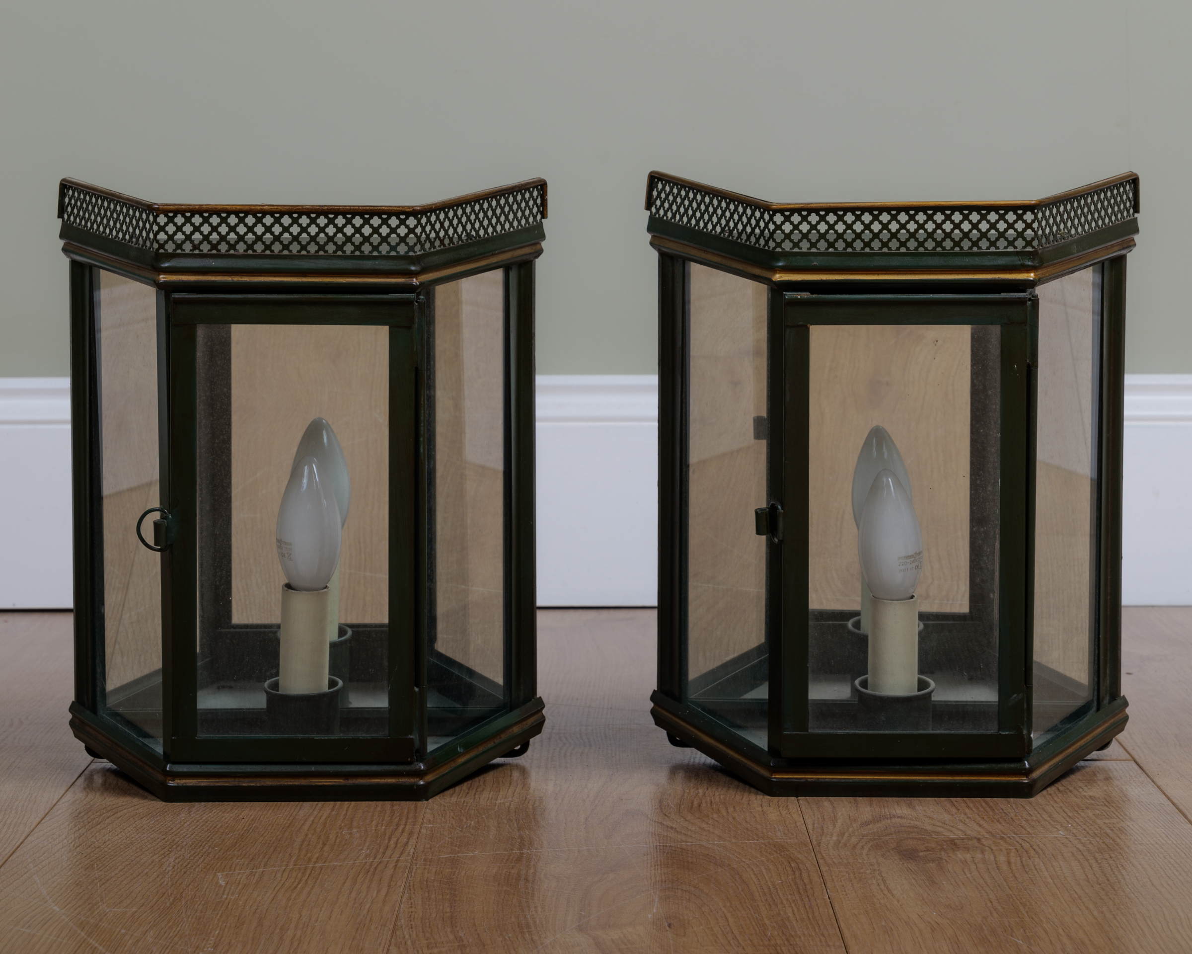 Appraisal: A pair of green painted and parcel gilt toleware lanterns