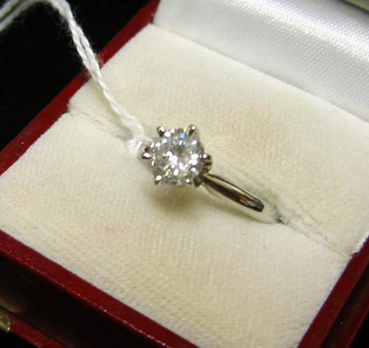 Appraisal: DIAMOND AND FOURTEEN KARAT WHITE GOLD SOLITAIRE RING WITH APPRAISAL