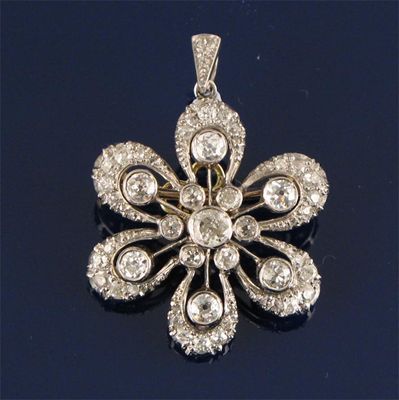 Appraisal: A diamond flower head brooch pendant set overall with graduated