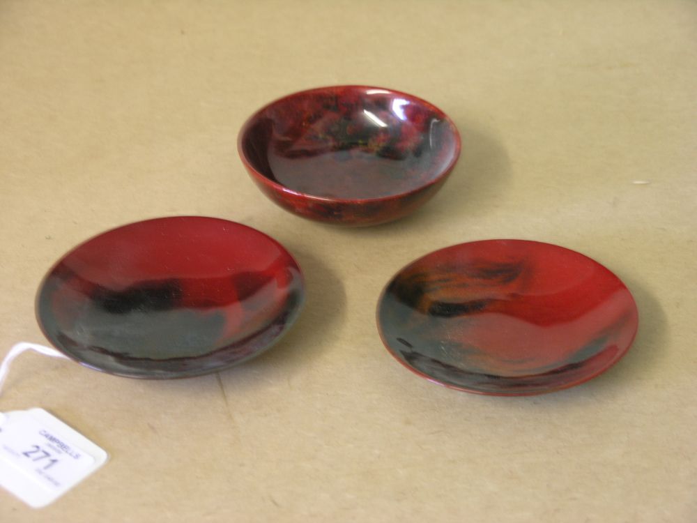 Appraisal: Three Royal Doulton flambe saucer dishes coloured glaze effects against