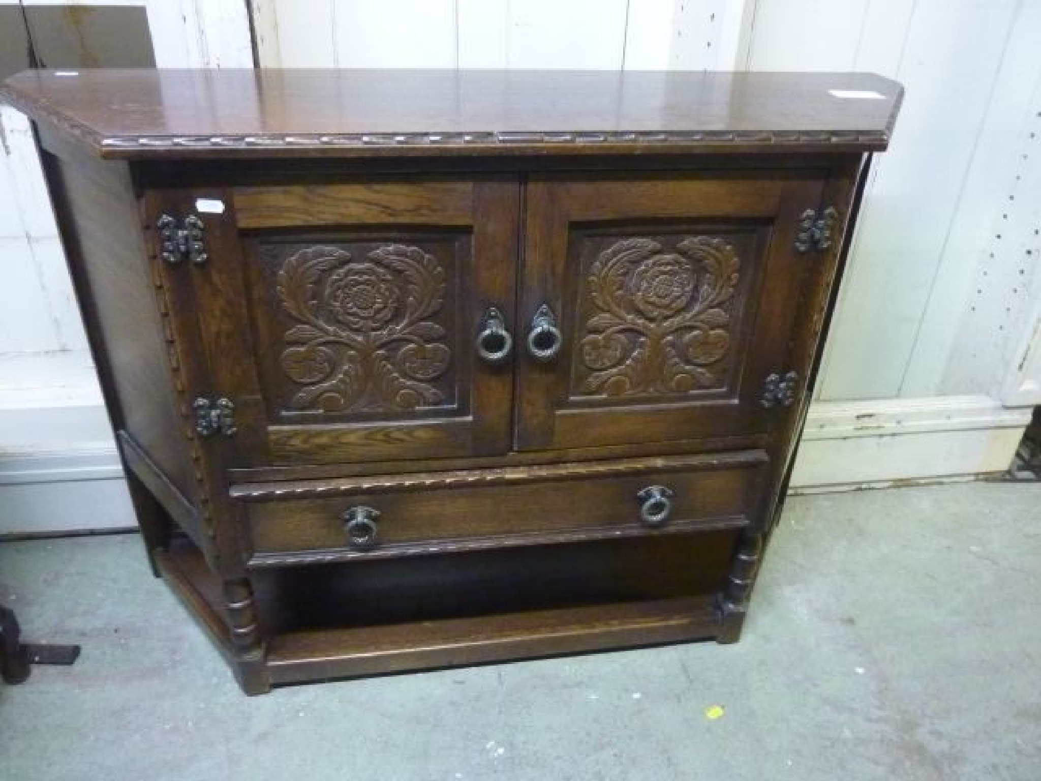 Appraisal: A reproduction oak credence cupboard enclosed by two carved and