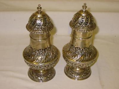 Appraisal: A PAIR OF VICTORIAN CASTERS of pear form with urn