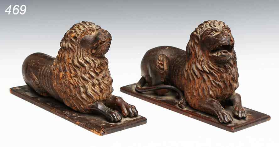 Appraisal: Pair of Swiss Carved Recumbant Lions '' long bases probably