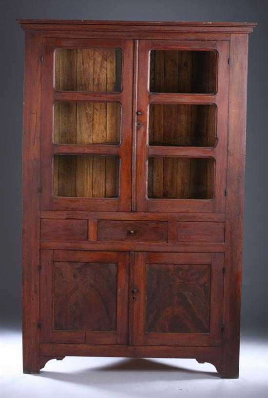 Appraisal: AMERICAN WALNUT COUNTRY CORNER CABINET th century Glazed panel doors