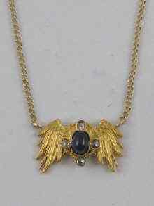 Appraisal: A hallmarked ct gold cabochon sapphire and diamond pendant necklace