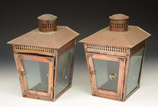 Appraisal: A PAIR OF COPPER THREE GLASS STATION CANDLE LANTERNS with