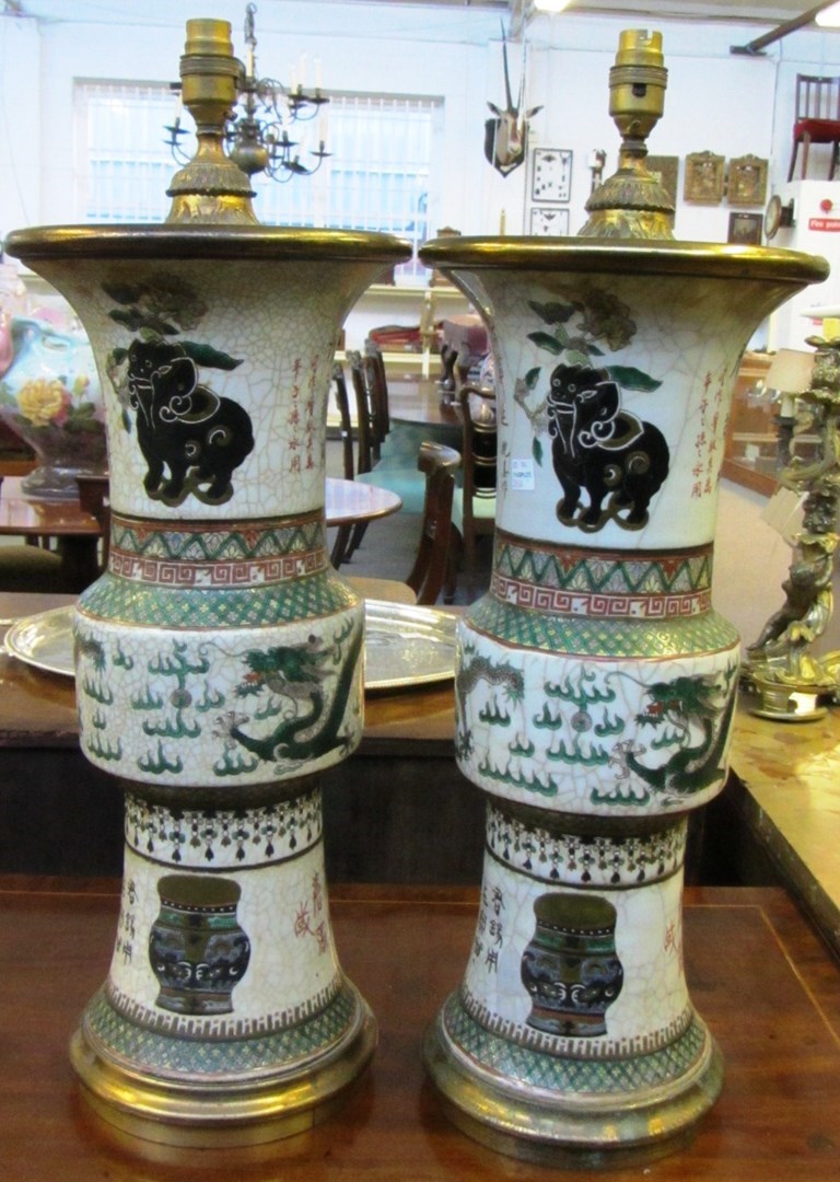 Appraisal: A pair of Chinese gilt-metal mounted crackle glazed gu-shaped vases