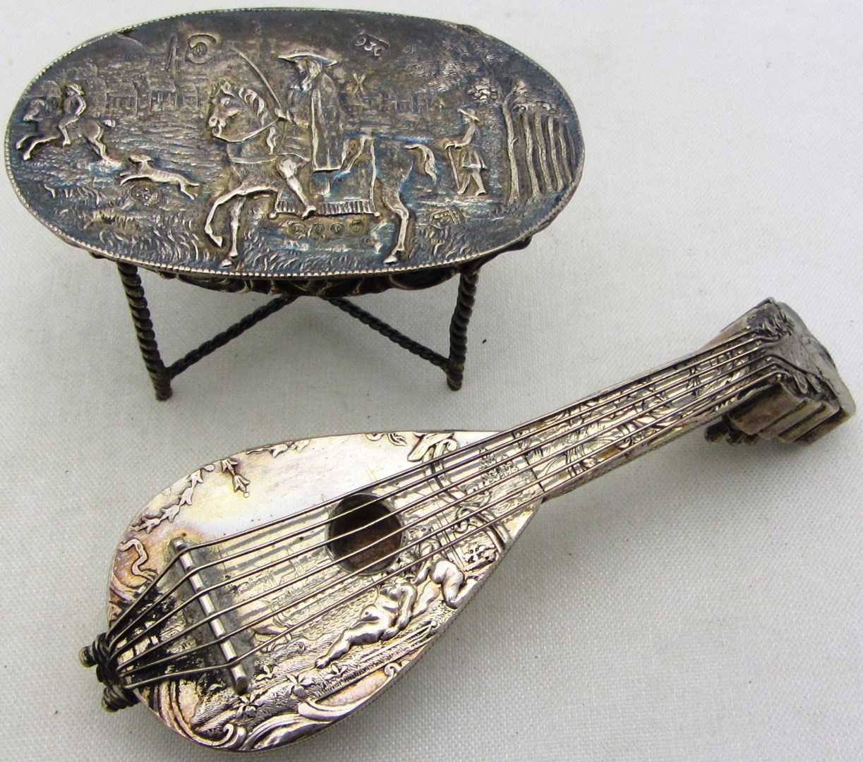 Appraisal: A model of a banjo probably Dutch decorated with putto