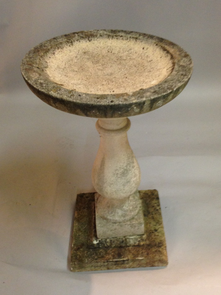 Appraisal: A composition stone bird bath with a dished top baluster