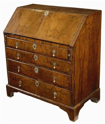 Appraisal: A walnut bureau crossbanded and inlaid feather stringing the hinged