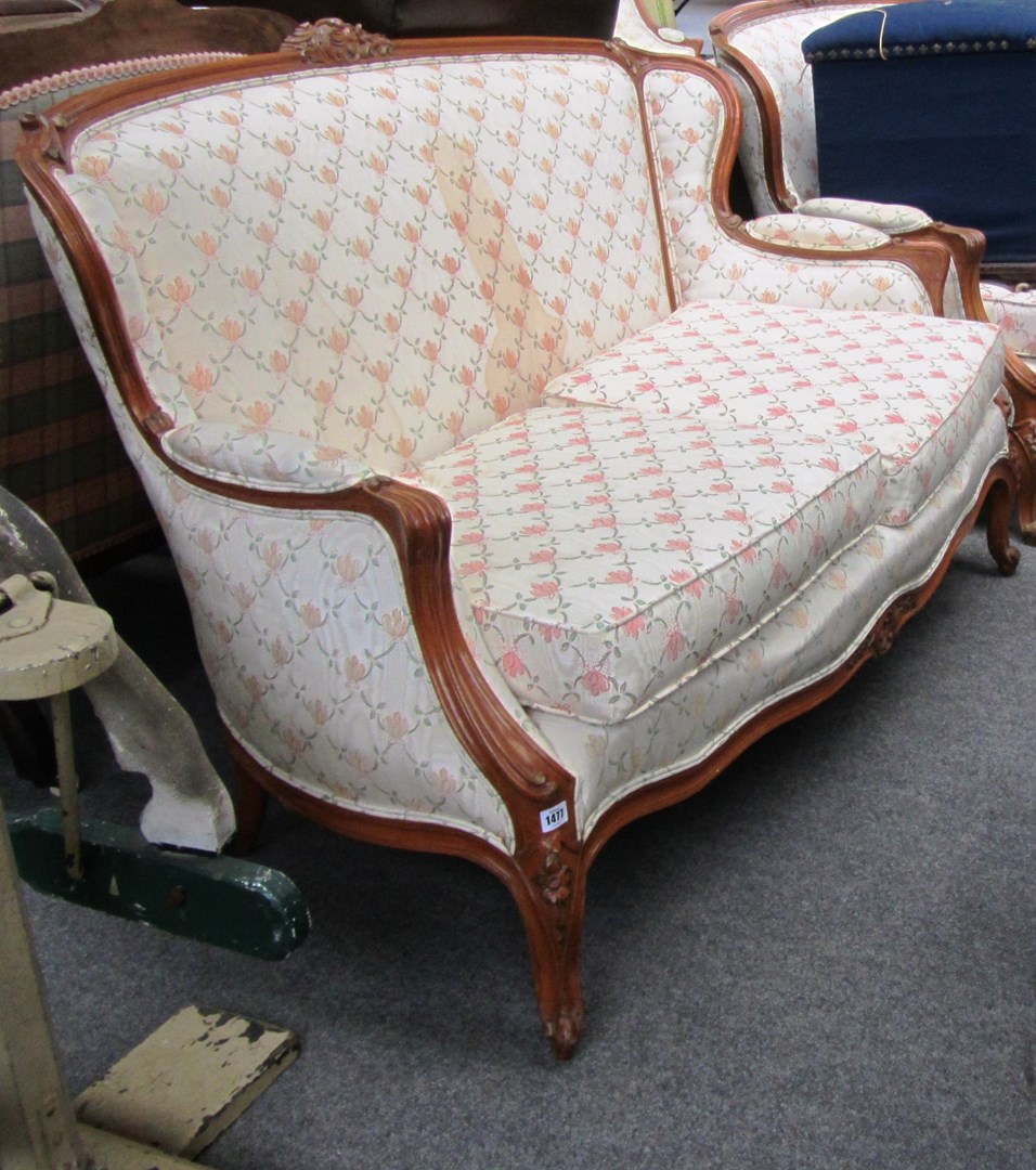 Appraisal: A pair of stained beech two seater sofas of Louis