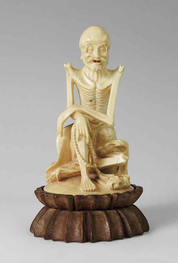 Appraisal: CHINESE CARVED IVORY SKELETAL LOHAN FIGURE Seated skeletal Lohan or