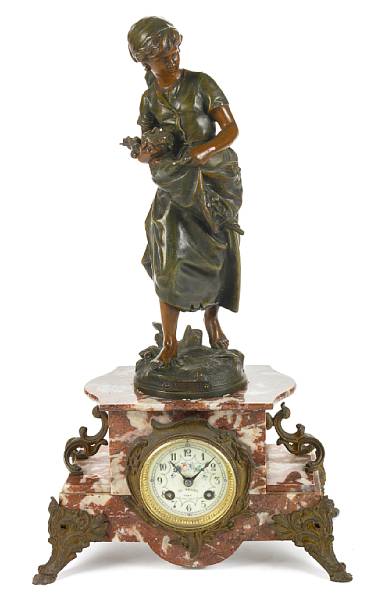 Appraisal: A French patinated metal and marble mantel clock surmounted by