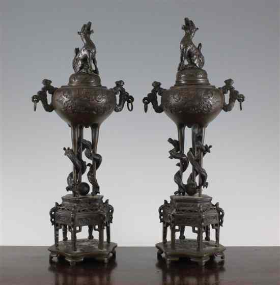 Appraisal: A pair of Japanese bronze tripod koros covers and stands