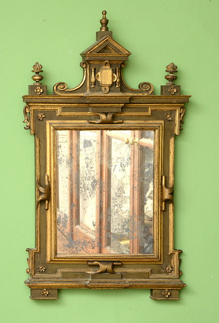 Appraisal: A CONTINENTAL HANGING WALL MIRROR with an architectural carved wood