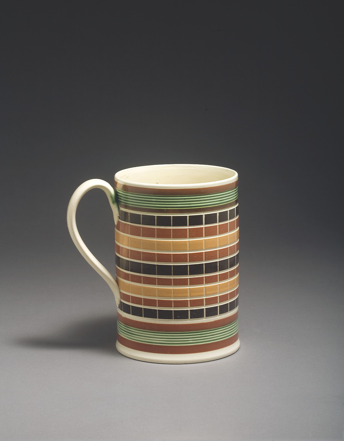 Appraisal: BRITISH CREAMWARE MOCHAWARE QUART MUG CIRCA Slip-banded in pumpkin dark