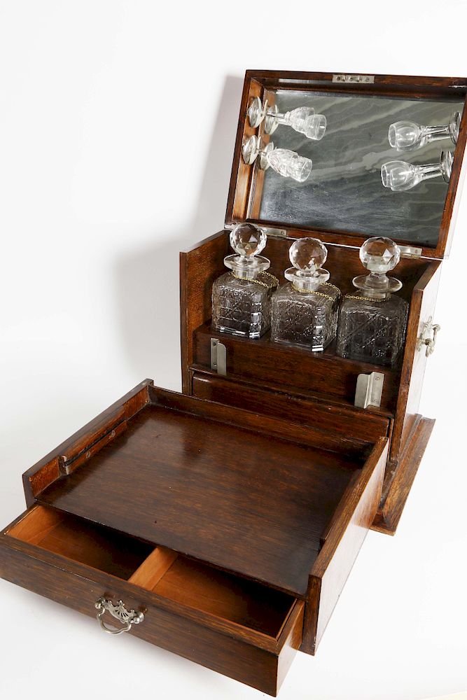 Appraisal: Oak and Silver Plate Mounted Tantalus with Three Crystal Decanters