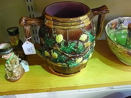 Appraisal: A MAJOLICA BROWN GLAZED TWO HANDLED BARREL with trailing vine