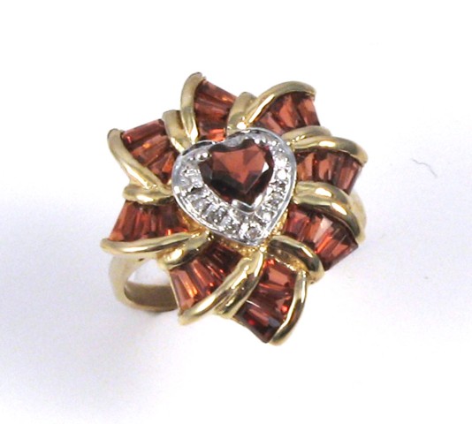 Appraisal: GARNET AND TEN KARAT GOLD RING set with a heart-cut