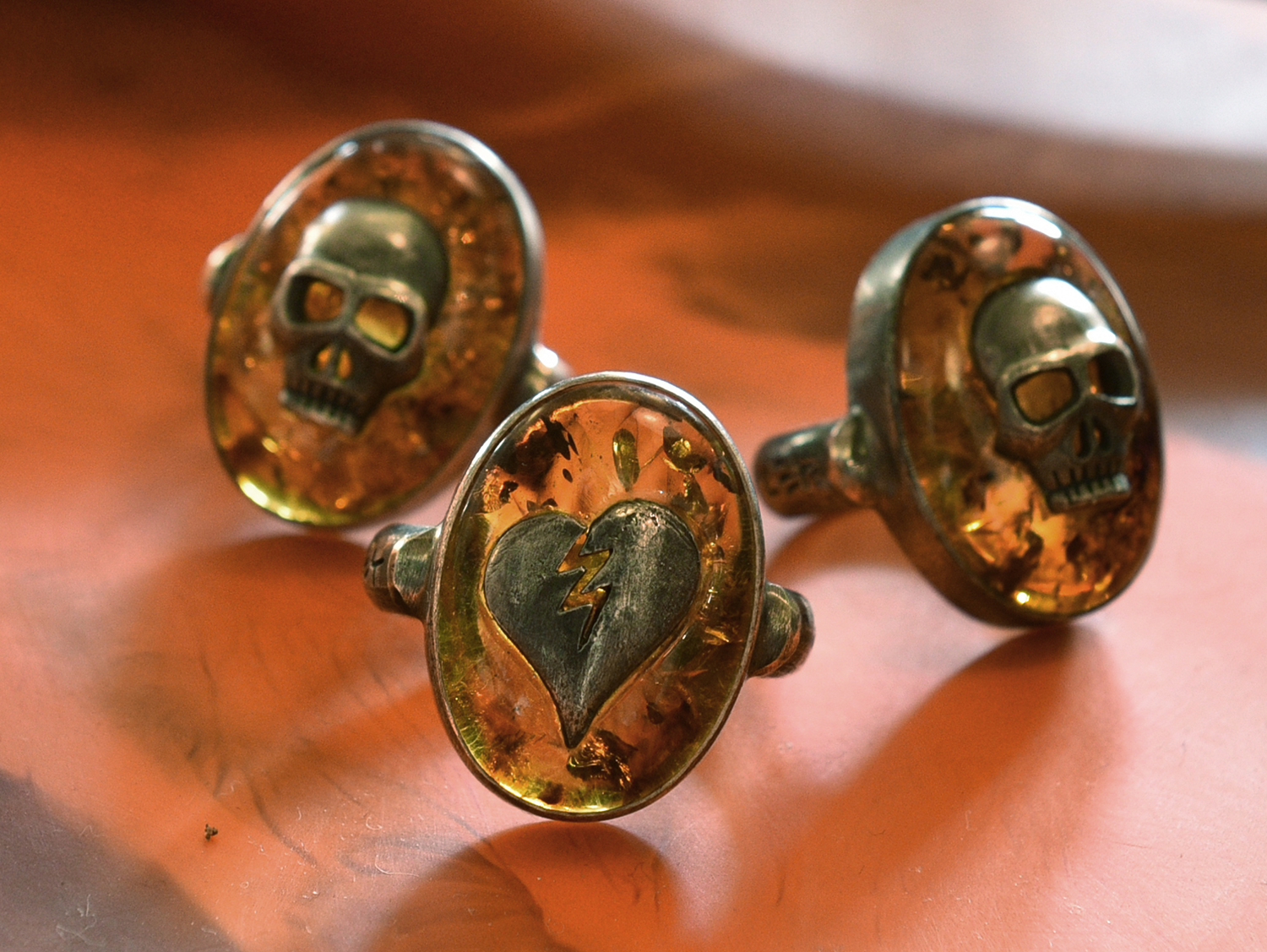 Appraisal: THREE STIRLING SILVER DAVID BROMLEY RINGS WITH SKULL AND HEART