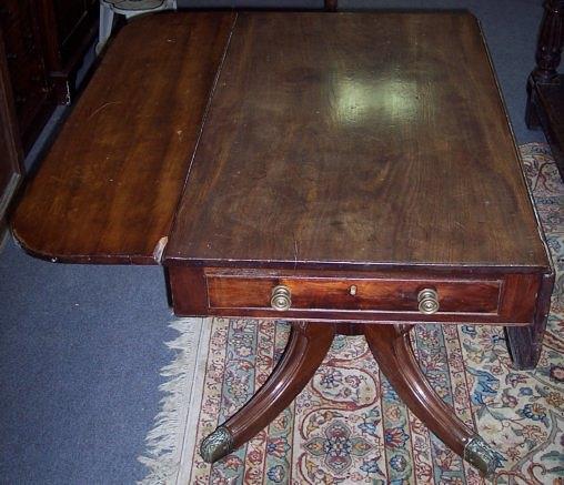 Appraisal: A Regency mahogany two-flap table fitted a drawer to each