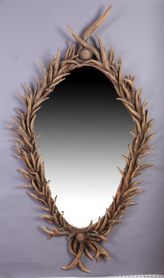 Appraisal: ADIRONDACK STYLE FAUX-HORN RESIN FRAME WALL MIRROR th century Cartouche