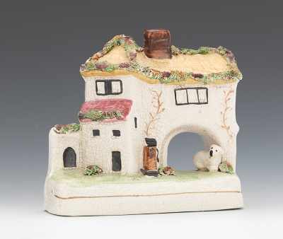 Appraisal: A Country House Charming glazed ceramic house with a dog