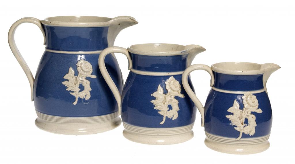 Appraisal: A GRADUATED SET OF THREE SPRIGGED WHITE WARE JUGS with