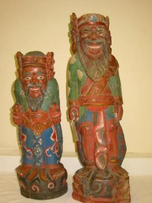 Appraisal: TWO SIMILAR FAR EASTERN CARVED WOOD FIGURES each modelled as