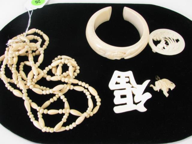 Appraisal: Group of ivory jewelry including two ivory pins elephant pendant