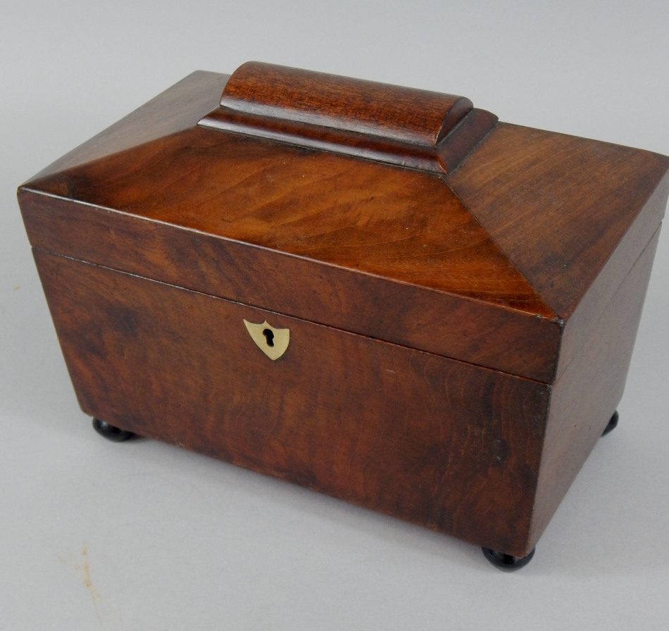 Appraisal: A Victorian sarcophagus shaped mahogany tea caddy the interior with